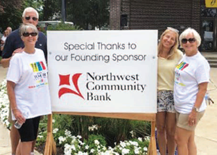 Community volunteers holding sign to thank founding sponsors of Northwest Community Bank