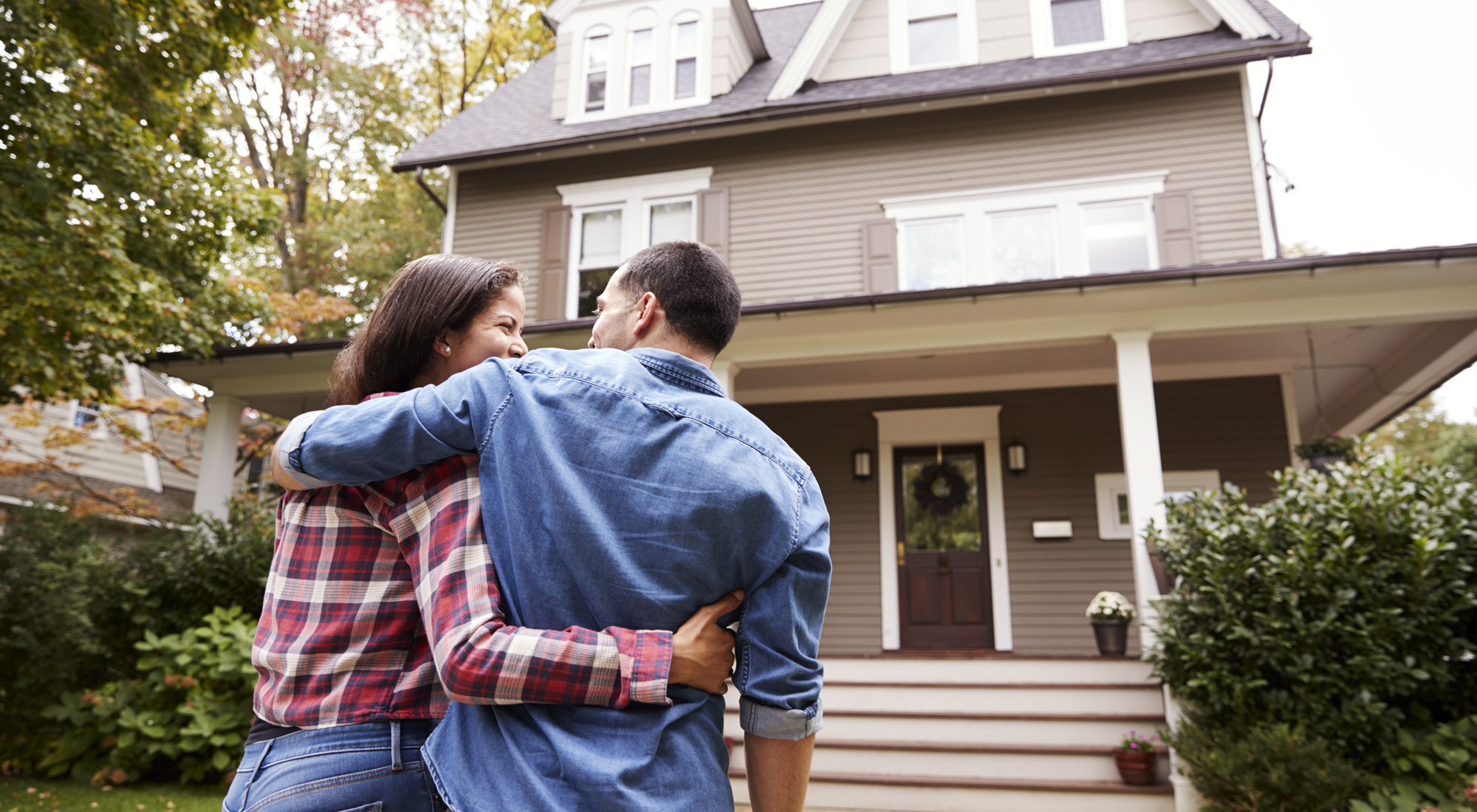 Rear View Of Loving Couple Walking Towards House